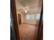 A cozy bedroom with pink carpet, a ceiling fan, and a closet for comfortable living at 10949 Sw 79Th Ter, Ocala, FL 34476