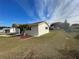 Side view of a single story house with landscaping and a palm tree at 10949 Sw 79Th Ter, Ocala, FL 34476