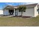 Exterior view of a yellow single story house with a covered porch and landscaped yard at 10949 Sw 79Th Ter, Ocala, FL 34476