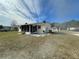 View of a single-story house with a large yard and screened patio at 10949 Sw 79Th Ter, Ocala, FL 34476
