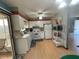 Kitchen with white appliances and light wood floors at 10949 Sw 79Th Ter, Ocala, FL 34476