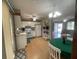 Kitchen with white appliances, light wood floors, and access to a patio at 10949 Sw 79Th Ter, Ocala, FL 34476