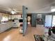 Open concept kitchen with white appliances and light wood floors at 10949 Sw 79Th Ter, Ocala, FL 34476