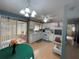 Kitchen boasts white cabinets, light wood floors, and a view to the patio at 10949 Sw 79Th Ter, Ocala, FL 34476