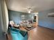 Bright living room featuring light wood floors and comfortable seating at 10949 Sw 79Th Ter, Ocala, FL 34476