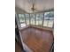 A screened porch with tile flooring and panoramic views of the surrounding outdoors at 10949 Sw 79Th Ter, Ocala, FL 34476