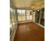 A screened-in porch featuring a patterned floor and view of the back yard and kitchen at 10949 Sw 79Th Ter, Ocala, FL 34476