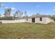 Expansive backyard featuring lush grass, a privacy fence, and views of surrounding trees, perfect for outdoor activities at 13143 Sw 67Th Ave, Ocala, FL 34473