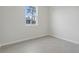 Bedroom featuring wood look tile flooring, base trim, and a window with backyard view at 13143 Sw 67Th Ave, Ocala, FL 34473
