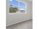 Bright bedroom features wood look tile floor and a large window with neighborhood views at 13143 Sw 67Th Ave, Ocala, FL 34473