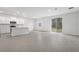 Bright, open-concept living space with sleek tile flooring and sliding glass doors leading to the backyard at 13143 Sw 67Th Ave, Ocala, FL 34473
