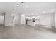 Bright, open-concept living space featuring neutral walls and tiled flooring adjacent to a modern, stylish kitchen at 13143 Sw 67Th Ave, Ocala, FL 34473