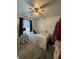 Bright bedroom featuring a double bed and ceiling fan at 14118 Se 45Th Ct, Summerfield, FL 34491