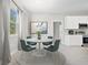 Small dining area with round table and four chairs, next to the kitchen at 15970 Sw 55Th Avenue Rd, Ocala, FL 34473