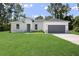 Single-story home with gray garage and stone accents at 16019 Sw 42Nd Ter, Ocala, FL 34473