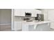 Kitchen island with white cabinets and quartz countertop at 16019 Sw 42Nd Ter, Ocala, FL 34473