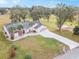 Aerial view of a house with solar panels and golf course view at 17999 Se 99Th Ave, Summerfield, FL 34491