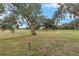 Landscaped backyard featuring a golf course view at 17999 Se 99Th Ave, Summerfield, FL 34491