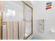 Bathroom with a shower and gold-framed glass door at 17999 Se 99Th Ave, Summerfield, FL 34491