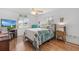 Cozy bedroom with a comfortable bed and hardwood floors at 17999 Se 99Th Ave, Summerfield, FL 34491