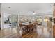 Bright dining room with hardwood floors, wood table and chairs, and view of the backyard at 17999 Se 99Th Ave, Summerfield, FL 34491