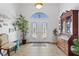 Bright and spacious entryway with tile floors and a wooden cabinet at 17999 Se 99Th Ave, Summerfield, FL 34491