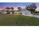 Two-story home with a three-car garage and manicured lawn at 17999 Se 99Th Ave, Summerfield, FL 34491