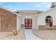 Inviting front entrance with double red doors and brick accents at 17999 Se 99Th Ave, Summerfield, FL 34491