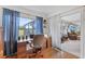 Home office with view into living room, hardwood floors, and built-in desk at 17999 Se 99Th Ave, Summerfield, FL 34491