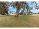 Home exterior showcasing a large backyard and golf course views at 17999 Se 99Th Ave, Summerfield, FL 34491