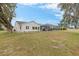 White house exterior with a screened patio and golf course views at 17999 Se 99Th Ave, Summerfield, FL 34491