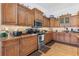 Updated kitchen with wood cabinets, granite counters & stainless steel appliances at 17999 Se 99Th Ave, Summerfield, FL 34491