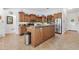 Spacious kitchen with an island, stainless steel appliances, and wood cabinets at 17999 Se 99Th Ave, Summerfield, FL 34491