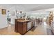 Open concept kitchen with island and views into dining area at 17999 Se 99Th Ave, Summerfield, FL 34491