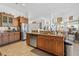 Large kitchen with island, granite countertops, and stainless steel appliances at 17999 Se 99Th Ave, Summerfield, FL 34491