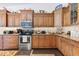 Well-equipped kitchen with ample counter space and wood cabinets at 17999 Se 99Th Ave, Summerfield, FL 34491