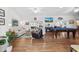 Living room with hardwood floors, pool table, and large TV at 17999 Se 99Th Ave, Summerfield, FL 34491