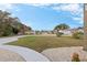 Landscaped neighborhood street view with lush green lawns at 17999 Se 99Th Ave, Summerfield, FL 34491