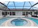 Circular spa with screened enclosure and adjacent pool at 17999 Se 99Th Ave, Summerfield, FL 34491