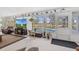 Sunroom with large windows overlooking the pool and golf course at 17999 Se 99Th Ave, Summerfield, FL 34491