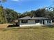 Newly renovated home with gray roof, solar panels, and white exterior at 1890 Sw Shorewood Dr, Dunnellon, FL 34431