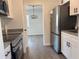 Bright kitchen featuring stainless steel appliances, white cabinets, and sleek countertops at 1890 Sw Shorewood Dr, Dunnellon, FL 34431