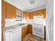 View of kitchen with wood cabinets and white appliances at 20 Pine Trace Run, Ocala, FL 34472