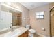 Well-maintained bathroom with neutral tones, tiled shower, vanity, and fixtures at 2105 Sw 4Th St, Ocala, FL 34471