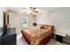 Cozy bedroom with a comfortable bed, soft lighting, and window overlooking the backyard at 2105 Sw 4Th St, Ocala, FL 34471