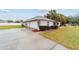 Well-maintained home features an attached two-car garage, lush landscaping, and a spacious driveway at 2105 Sw 4Th St, Ocala, FL 34471