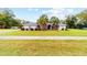 Charming single Gathering home boasts lush landscaping, palm trees, and a well manicured lawn at 2105 Sw 4Th St, Ocala, FL 34471