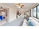 Bright and airy living room with neutral tones, plush seating, ceiling fan, and expansive windows at 2105 Sw 4Th St, Ocala, FL 34471