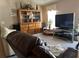 Cozy living room with large screen television and a large wooden cabinet at 2105 Sw 4Th St, Ocala, FL 34471