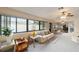 Spacious living area with large windows offering natural light, plush couches, and ceiling fan at 2105 Sw 4Th St, Ocala, FL 34471